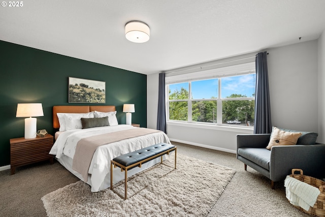 bedroom featuring baseboards and carpet flooring