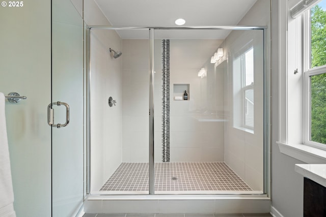 bathroom featuring vanity, tile patterned flooring, and a shower stall