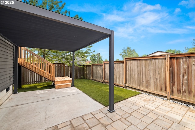 view of patio / terrace with a fenced backyard and stairs