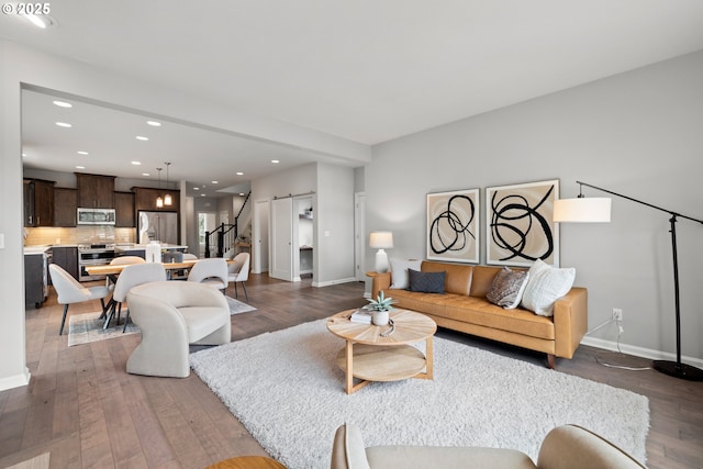 living room with recessed lighting, baseboards, stairs, and wood finished floors