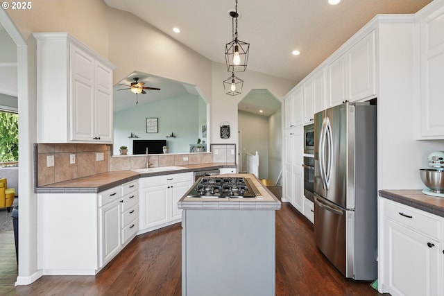 16117 SE Goosehollow Dr, Damascus, OR 97089 - kitchen with appliances with stainless steel finishes, tile counters, a center island, lofted ceiling, and recessed lighting