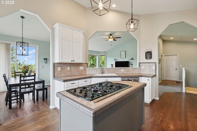16117 SE Goosehollow Dr, Damascus, OR 97089 - kitchen featuring black gas cooktop, a ceiling fan, white cabinetry, dark wood finished floors, and backsplash