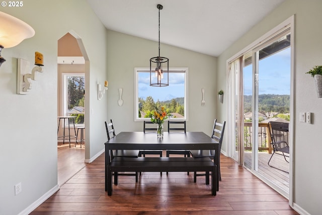 16117 SE Goosehollow Dr, Damascus, OR 97089 - dining room featuring lofted ceiling, dark wood finished floors, healthy amount of natural light, and arched walkways