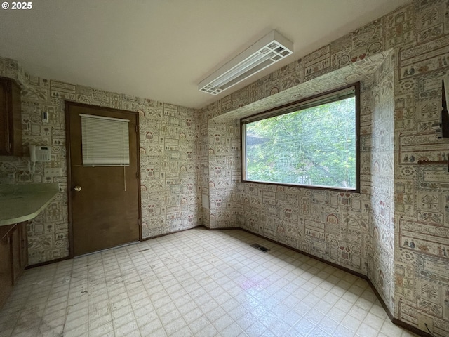 unfurnished room featuring light floors