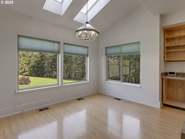 17234 Oakdale Rd, Dallas, OR 97338 - unfurnished dining area featuring visible vents, an inviting chandelier, light wood-style floors, and vaulted ceiling with skylight
