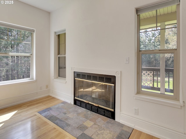 17234 Oakdale Rd, Dallas, OR 97338 - room details with a glass covered fireplace, wood finished floors, and baseboards