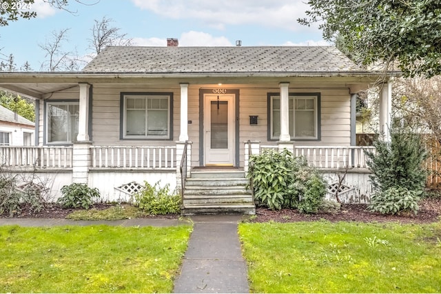 844 SE Cedar St, Hillsboro, OR 97123 - bungalow-style house featuring a chimney, a porch, a front lawn, and a shingled roof