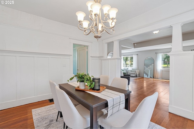 7315 N Smith St, Portland, OR 97203 - dining space featuring a decorative wall, decorative columns, a chandelier, light wood finished floors, and a wainscoted wall