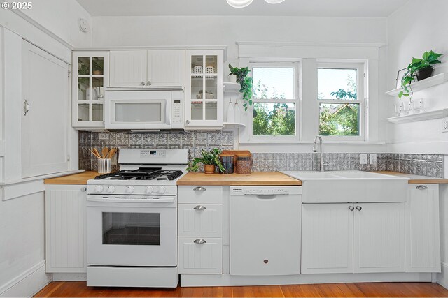7315 N Smith St, Portland, OR 97203 - kitchen with white appliances, butcher block counters, white cabinetry, and glass insert cabinets