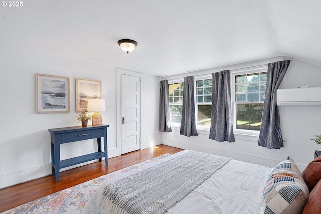 7315 N Smith St, Portland, OR 97203 - bedroom with an AC wall unit, wood finished floors, and vaulted ceiling
