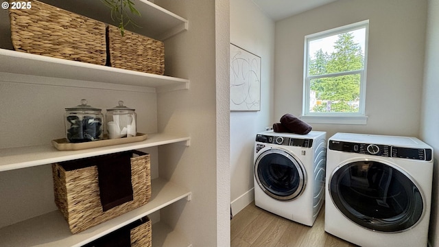17890 SW Alvord Ln, Beaverton, OR 97007 - laundry area with washer and clothes dryer and light wood-style floors