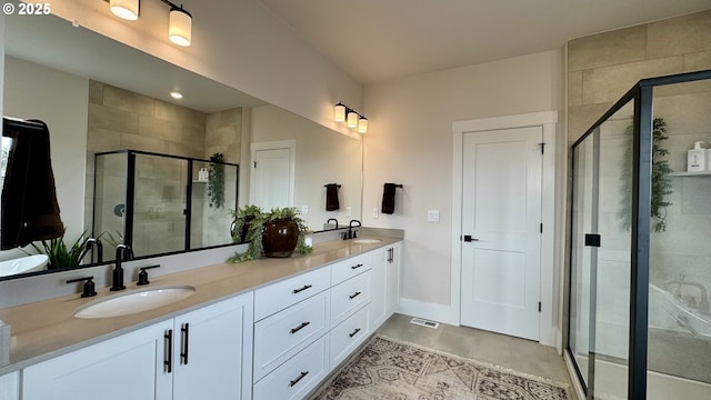 17890 SW Alvord Ln, Beaverton, OR 97007 - bathroom featuring double vanity, a stall shower, and tile patterned flooring