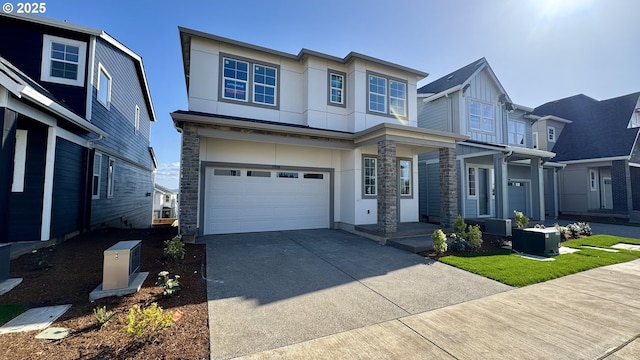 17890 SW Alvord Ln, Beaverton, OR 97007 - view of front of home featuring an attached garage, stone siding, driveway, and stucco siding