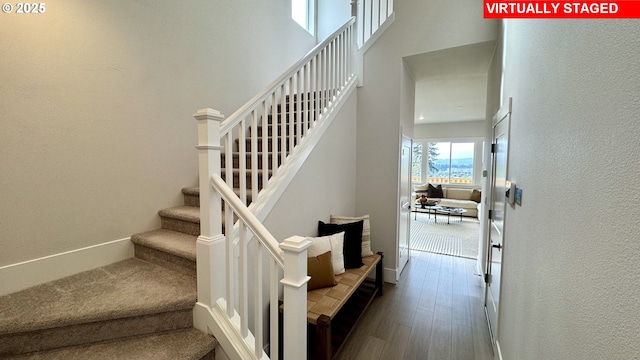 17890 SW Alvord Ln, Beaverton, OR 97007 - stairway featuring wood finished floors, a high ceiling, and a textured wall