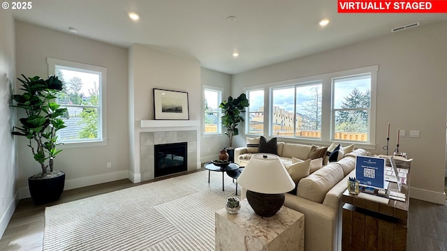 17890 SW Alvord Ln, Beaverton, OR 97007 - living room featuring wood finished floors, a tiled fireplace, and recessed lighting