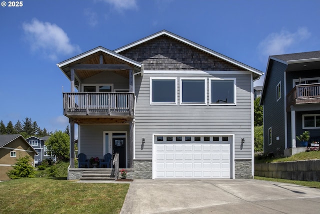 2343 N Fork Rd, Seaside, OR 97138 - view of front of property with a balcony, a garage, driveway, and stone siding