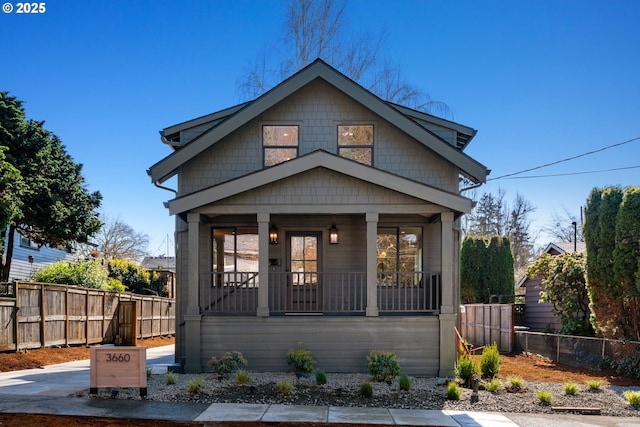 view of front of house featuring covered porch and fence