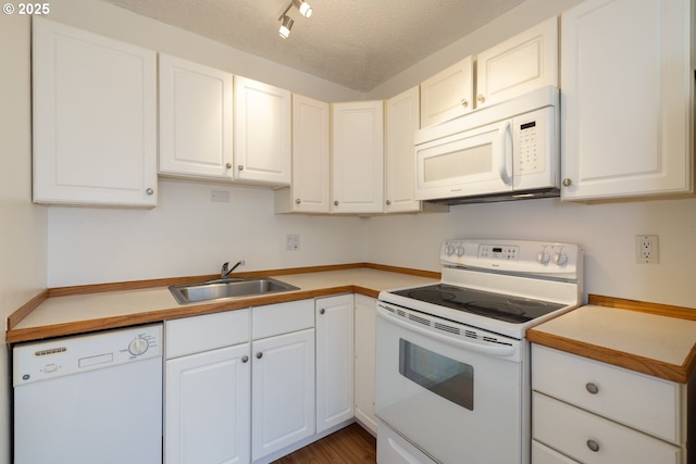 kitchen with white cabinets, white appliances, and sink