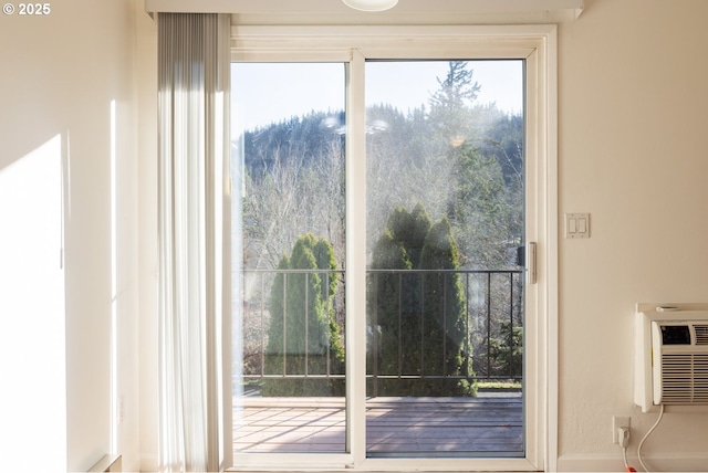 doorway to outside with a wall unit AC