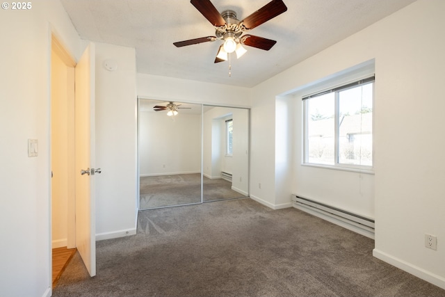 unfurnished bedroom featuring carpet flooring, ceiling fan, a closet, and a baseboard heating unit