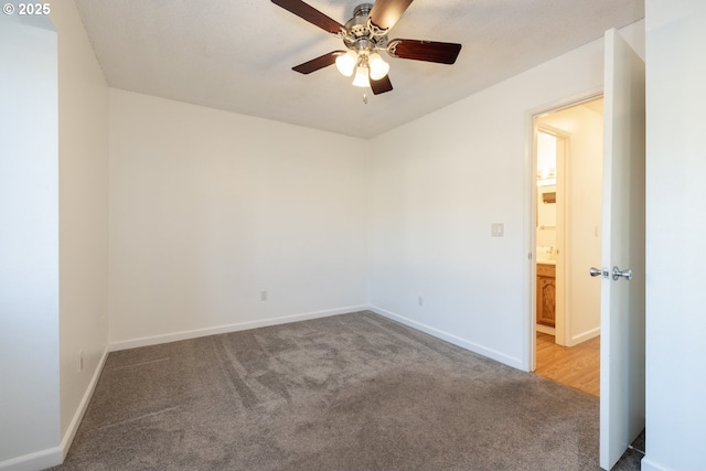 spare room featuring light carpet and ceiling fan