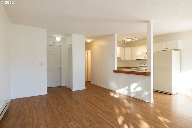 unfurnished living room with a textured ceiling, light hardwood / wood-style floors, and a baseboard radiator