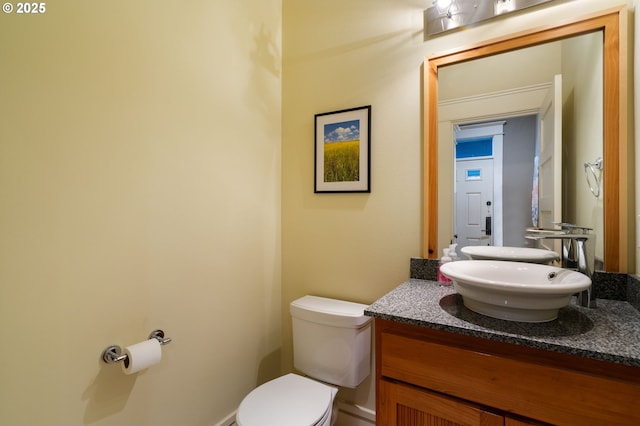half bathroom with toilet and vanity