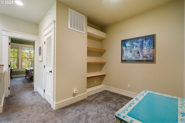 corridor featuring carpet and baseboards