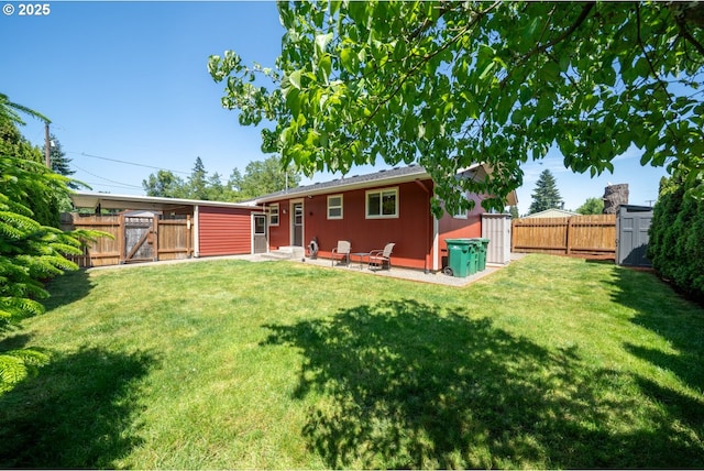 33218 SW Day St, Scappoose, OR 97056 - rear view of house featuring a gate, a fenced backyard, and a storage unit
