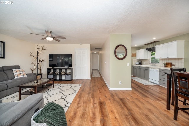 33218 SW Day St, Scappoose, OR 97056 - living room featuring light wood-type flooring, a ceiling fan, a textured ceiling, and recessed lighting