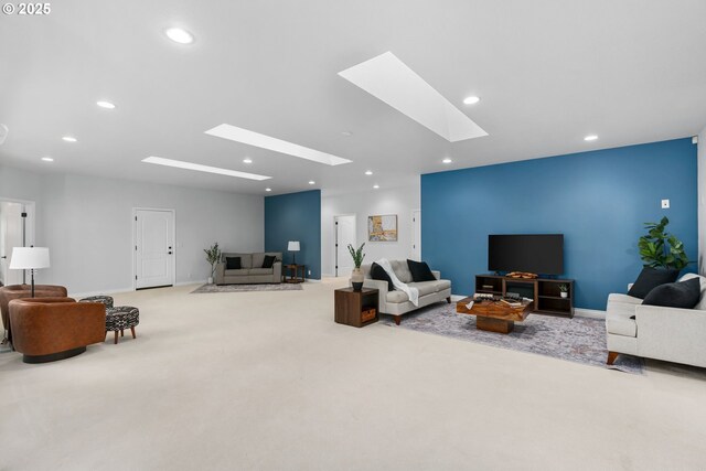 carpeted living room with a skylight