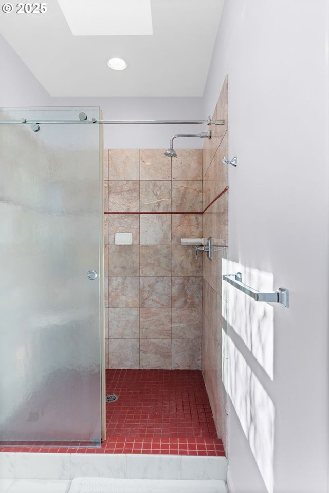 bathroom with walk in shower and a skylight