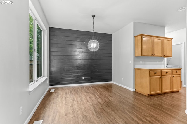 21125 SW Ladyfern Dr, Sherwood, OR 97140 - unfurnished dining area with wood finished floors, baseboards, and a chandelier