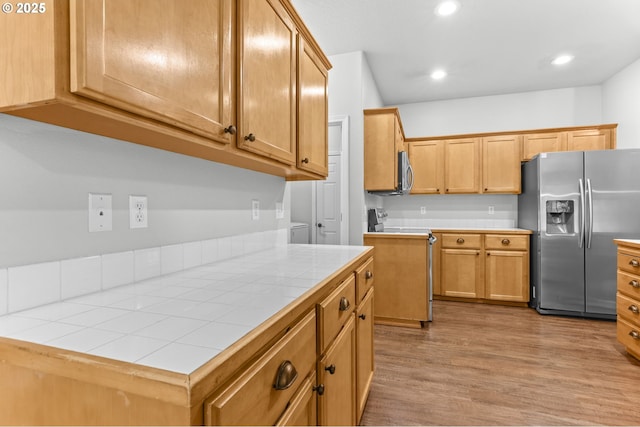 21125 SW Ladyfern Dr, Sherwood, OR 97140 - kitchen featuring appliances with stainless steel finishes, tile counters, wood finished floors, and recessed lighting