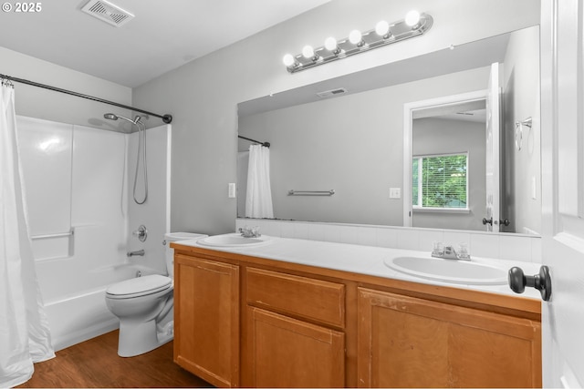 21125 SW Ladyfern Dr, Sherwood, OR 97140 - full bath featuring toilet, double vanity, shower / bath combo with shower curtain, and wood finished floors