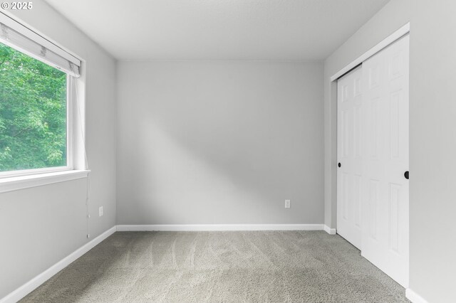21125 SW Ladyfern Dr, Sherwood, OR 97140 - unfurnished bedroom featuring carpet flooring, a closet, and baseboards