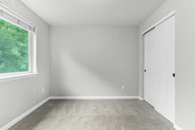 21125 SW Ladyfern Dr, Sherwood, OR 97140 - unfurnished bedroom featuring carpet flooring, a closet, and baseboards