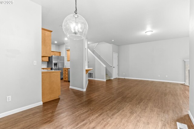 21125 SW Ladyfern Dr, Sherwood, OR 97140 - unfurnished living room with stairway, wood finished floors, a chandelier, and baseboards