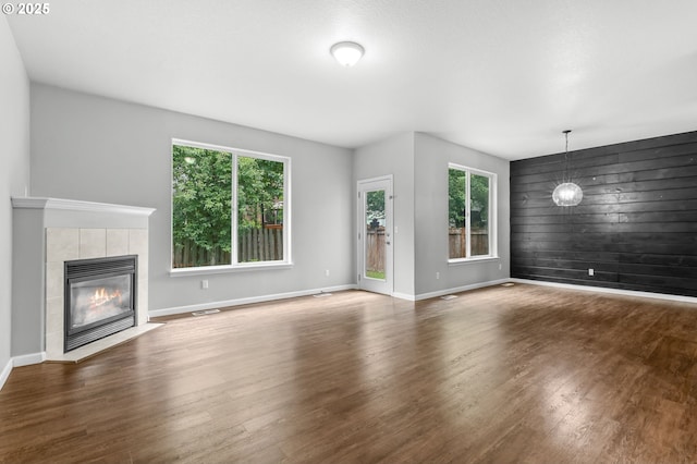 21125 SW Ladyfern Dr, Sherwood, OR 97140 - unfurnished living room with a fireplace, wood finished floors, baseboards, and wood walls