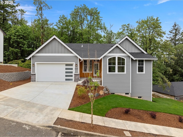 8120 SE 145th Ct, Portland, OR 97236 - view of front of home featuring board and batten siding, a garage, driveway, a front lawn, and roof with shingles