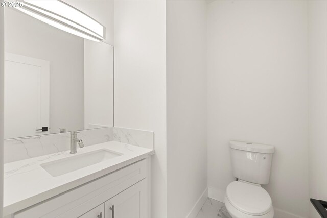 8120 SE 145th Ct, Portland, OR 97236 - bathroom with marble look tile flooring, baseboards, vanity, and toilet