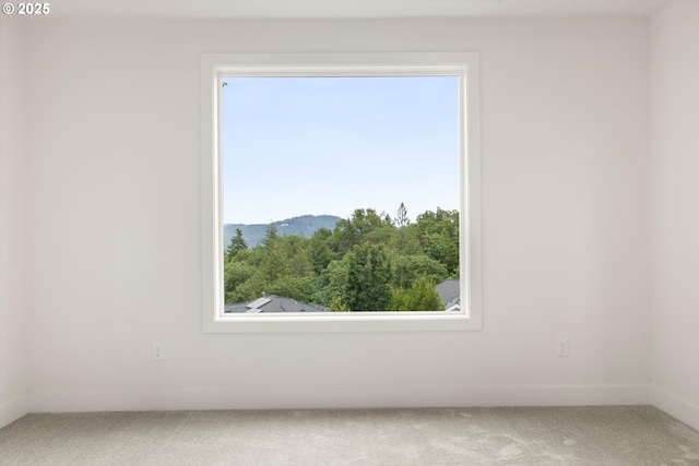 8120 SE 145th Ct, Portland, OR 97236 - spare room with carpet floors, a mountain view, and baseboards