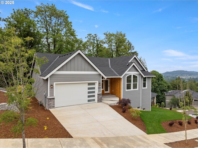 8120 SE 145th Ct, Portland, OR 97236 - view of front of house with board and batten siding, a garage, roof with shingles, a front lawn, and driveway