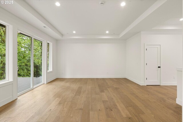 8120 SE 145th Ct, Portland, OR 97236 - spare room featuring a raised ceiling, plenty of natural light, light wood-type flooring, and recessed lighting