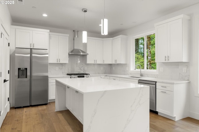 8120 SE 145th Ct, Portland, OR 97236 - kitchen featuring appliances with stainless steel finishes, wall chimney exhaust hood, a center island, recessed lighting, and white cabinetry