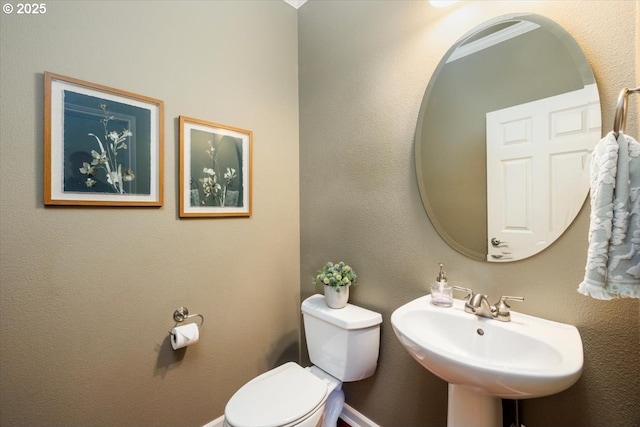 half bathroom with a sink and toilet