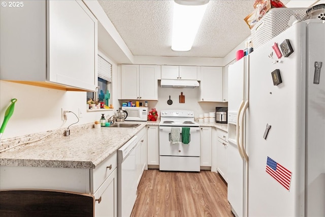 kitchen featuring white cabinets, a textured ceiling, white appliances, and light wood-type flooring