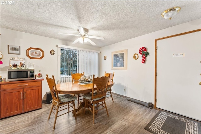 dining area featuring a textured ceiling, light hardwood / wood-style flooring, and ceiling fan