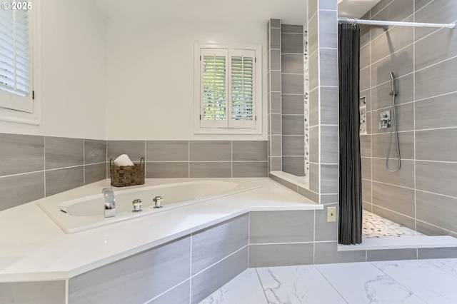 full bathroom featuring tiled shower, a garden tub, and marble finish floors