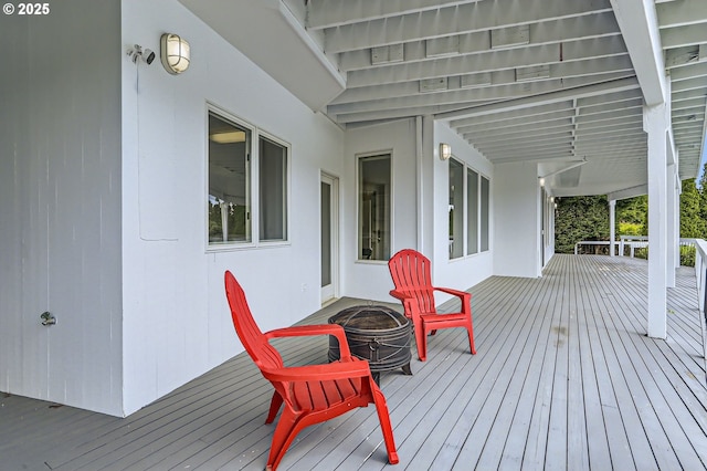 wooden deck with an outdoor fire pit